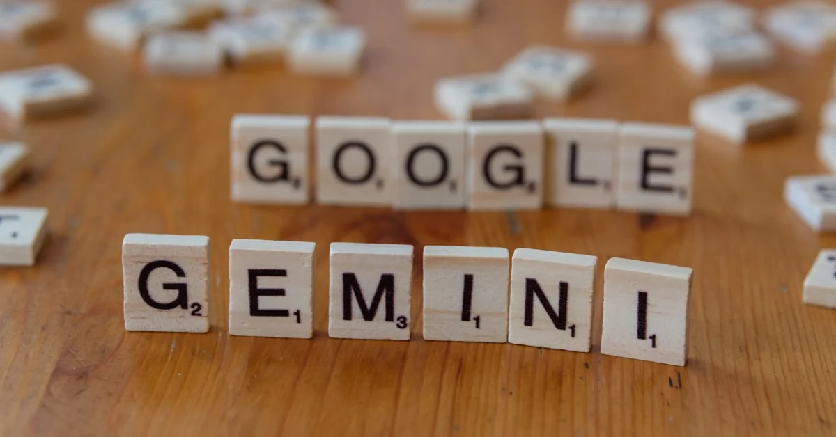 A wooden table topped with scrabble tiles spelling google, genni, and